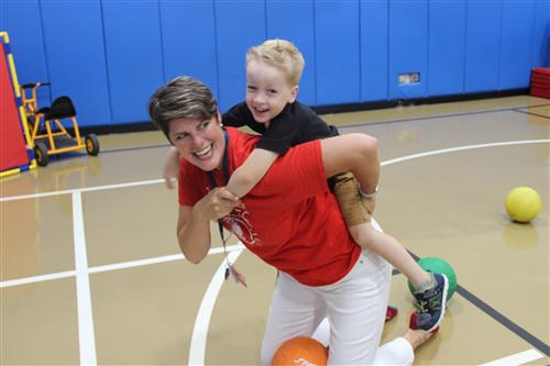 Illinois Park Principal Apryl Lowe playing in gym with a preschooler 